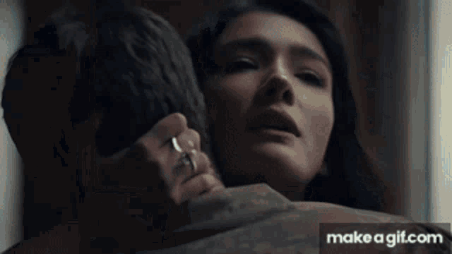 a woman with a ring on her finger is being held by a man