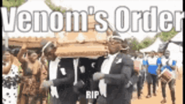a man in a suit is carrying a coffin in a parade .