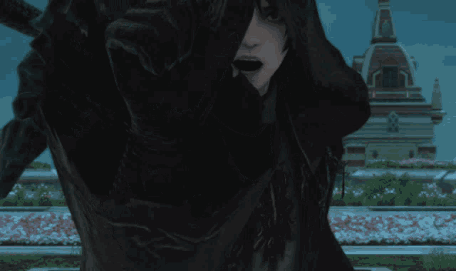 a man in a black hooded jacket is pointing at something