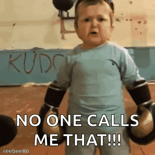 a baby wearing boxing gloves says " no one calls me that !!! "