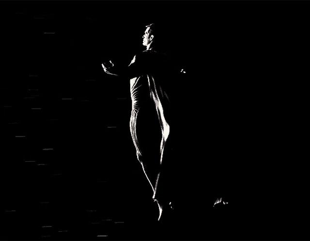 a man is flying through the air in the dark .