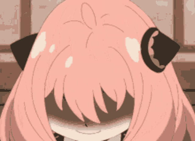 a close up of a cartoon girl with pink hair and black ears .