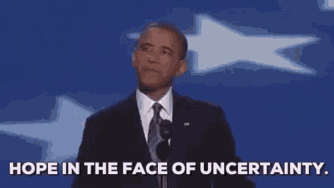 a man in a suit and tie is giving a speech and saying `` hope in the face of uncertainty . ''