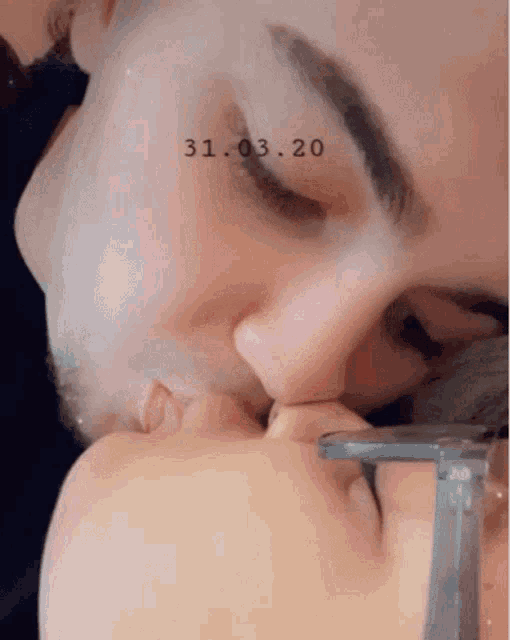 a man and a woman kissing with the date 31.03.20 on the bottom