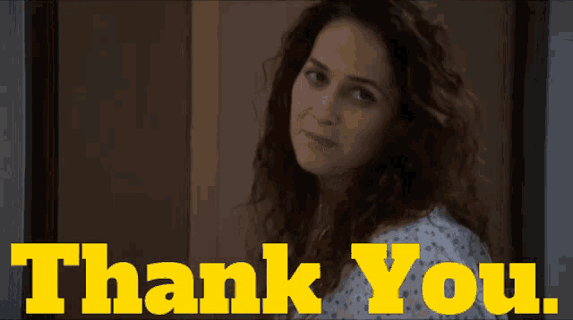 a woman in a hospital gown is standing in front of a sign that says thank you