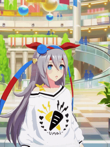 a girl wearing a umai shirt stands in a mall