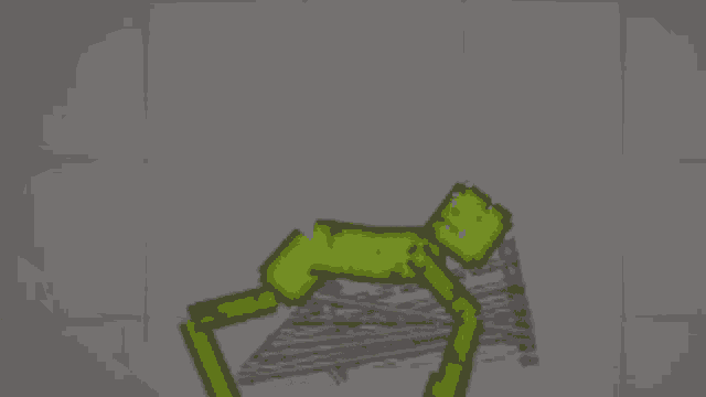 a green stick figure is standing next to a pile of sticks