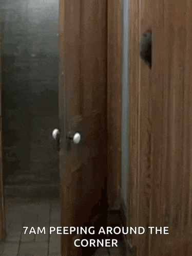 a man peeking out of a wooden door with the words " 7am peeping around the corner " on the bottom