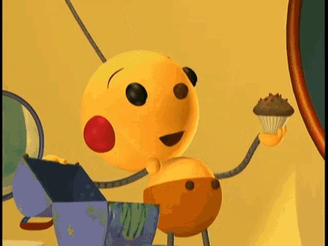 a yellow cartoon character with a red nose is holding a cupcake in his hand