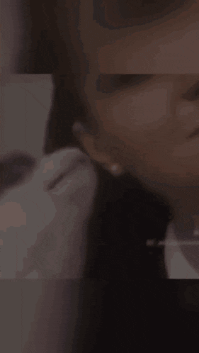 a close up of a woman 's face with a cat licking it .