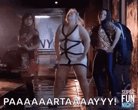 a group of women are standing next to each other on a sidewalk and dancing .