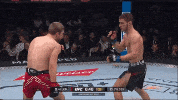 two men are fighting in a boxing ring with a featherweight bout between allen and evldev