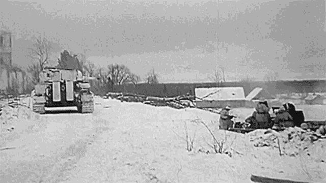 a black and white photo of two military vehicles driving through the snow