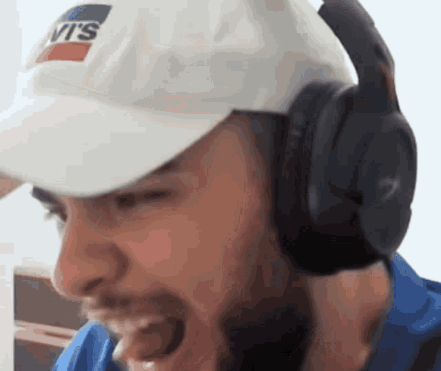 a man wearing headphones and a white hat with the word levis on it