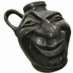 a black vase with a smiling face carved into it .