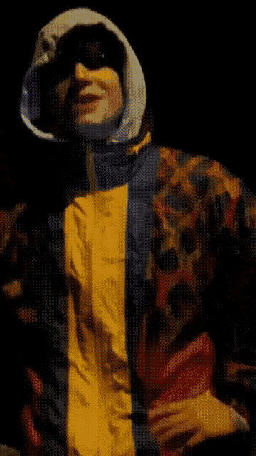 a man in a colorful jacket with a hood