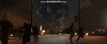 a group of people standing in front of a large robot with the website www.bandicam.com displayed