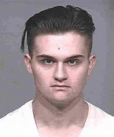 a young man with a ponytail is wearing a white shirt .