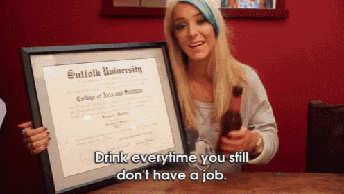 a woman is holding a framed suffolk university diploma