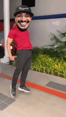 a man wearing a red shirt and a black hat that says wizzard