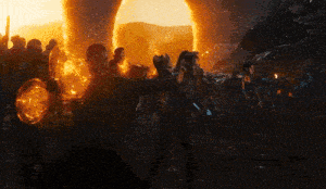 a group of people are standing in front of a large sun
