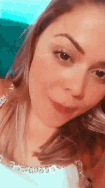 a close up of a woman 's face with a smile on her face .