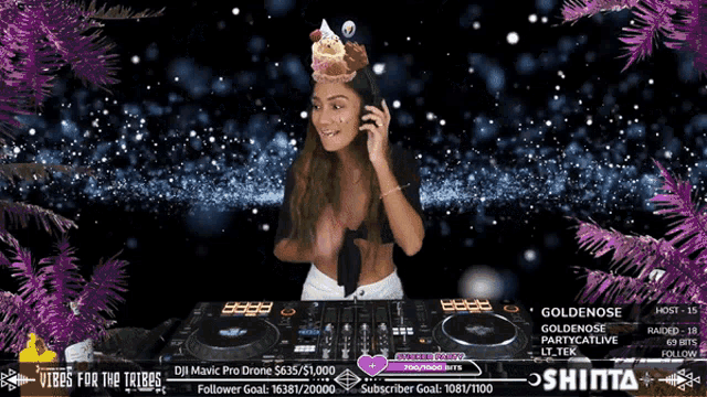 a woman wearing a birthday cake headband is playing music on a dj mixer
