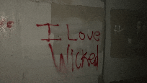i love wicked is written in red on a wall