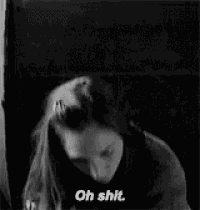 a woman is holding a camera and says `` oh shit '' .