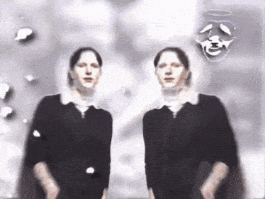 two people standing next to each other with a mask on their faces