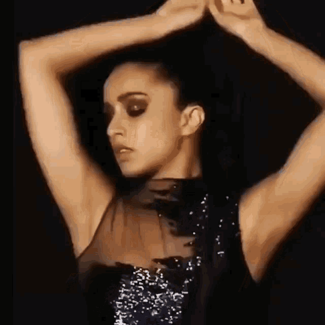 a close up of a woman 's armpit with her hands on her head .