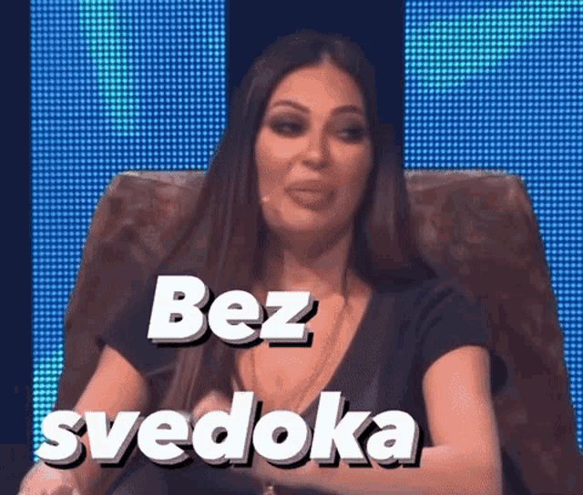 a woman is sitting in a chair with the words bez svedoka on the screen behind her