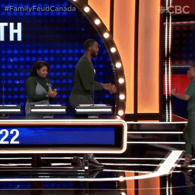 a man and a woman on a game show with the number 22