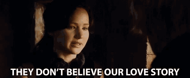 a woman is talking to a man in a dark room with the words `` they don 't believe our love story '' .