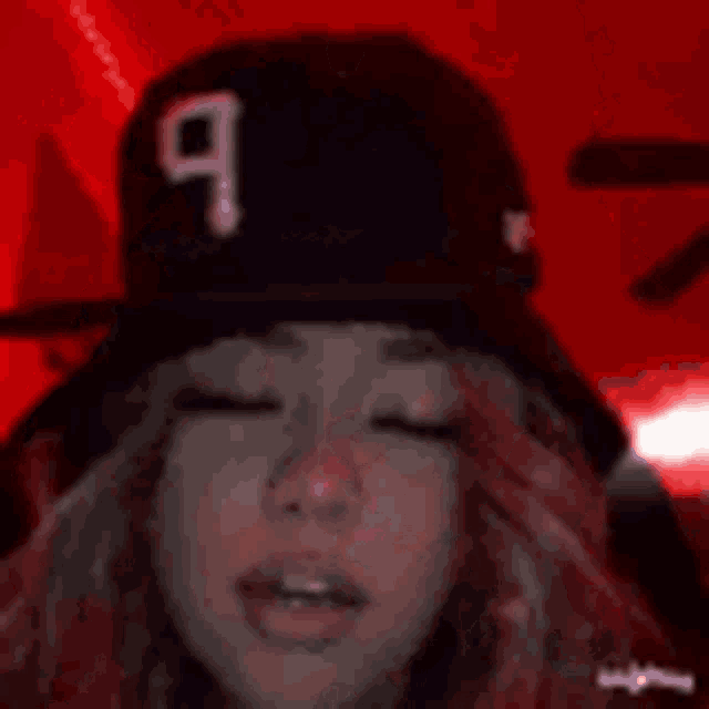 a girl is wearing a red hat with the number 9 on it .