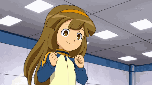 a girl with long brown hair is smiling in front of a ceiling that says tokyo