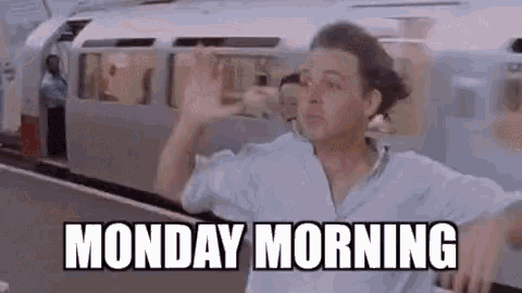 a man is standing in front of a train with the words monday morning .