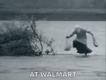 a black and white photo of an elderly woman running towards a river .