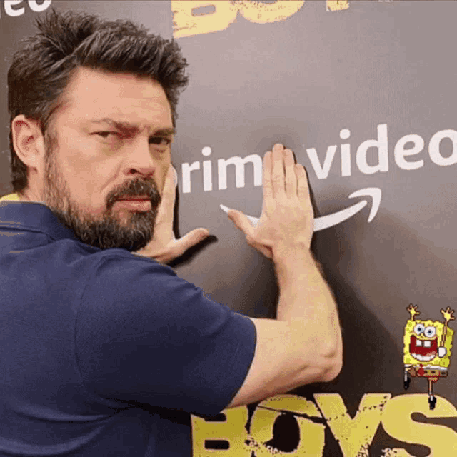 a man with a beard is touching a sign that says prime video boys
