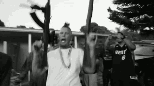 a man in a heat jersey holds a gun