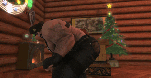 a man is kneeling down in a room with a christmas tree in the background