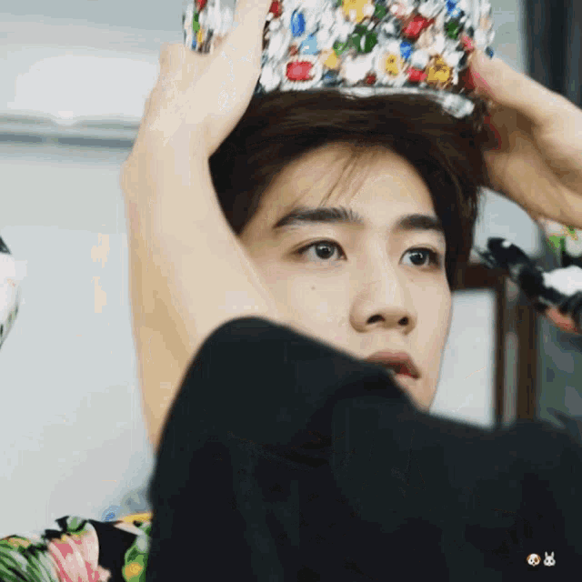 a close up of a person wearing a colorful crown