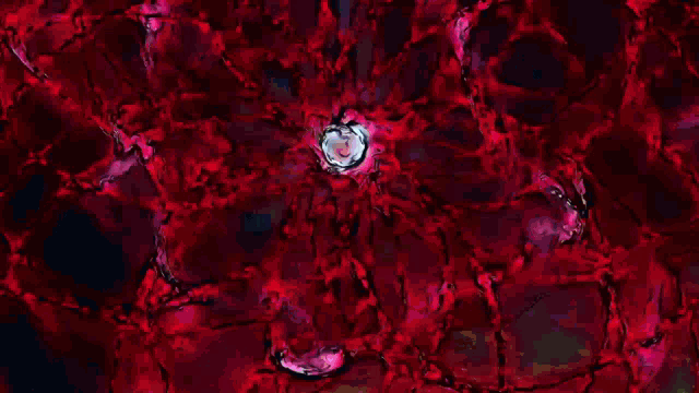a close up of a red flower with a blue center on a dark background .
