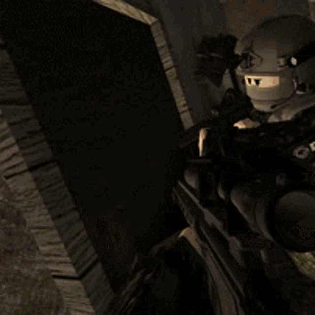 a man in a helmet and mask holding a gun