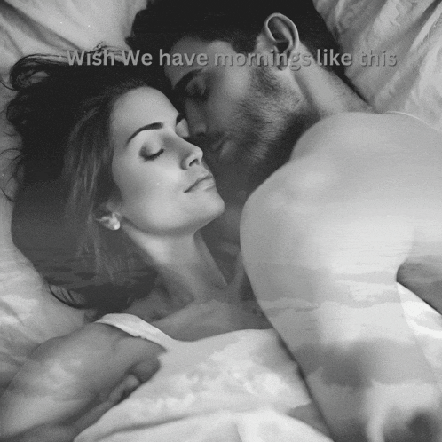 a black and white photo of a man and woman sleeping with the words wish we have mornings like this above them