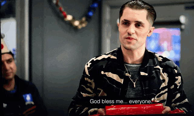 a man in a camo jacket is holding a red box and says god bless me everyone