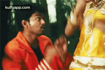 a man and a woman are dancing together in a movie .