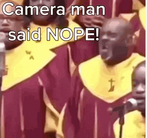 a group of men are singing into microphones in a choir .