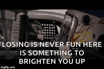 a man is sitting in the driver 's seat of a race car .