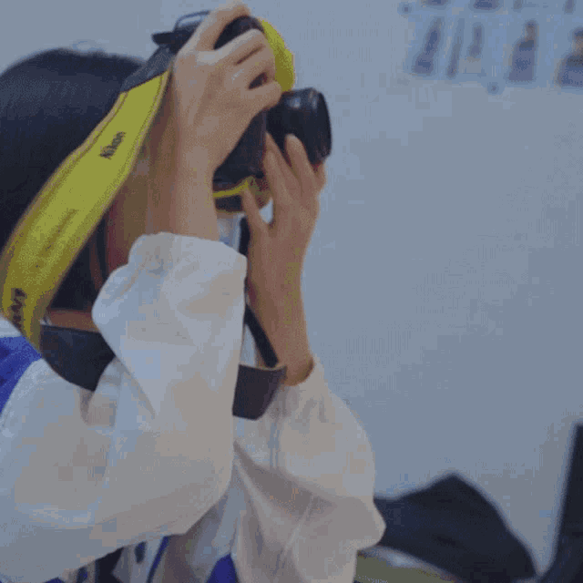 a person taking a picture with a camera that says canon